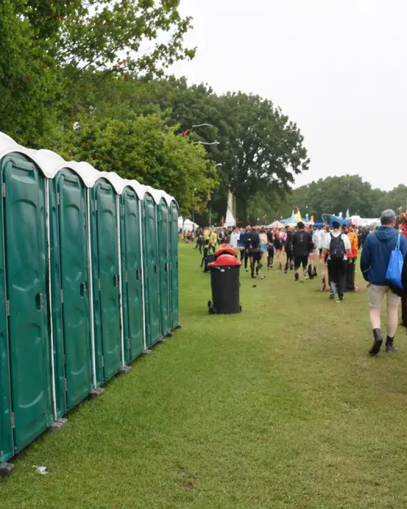 Clean Portable Toilets For Events In Use At Outdoor Festival